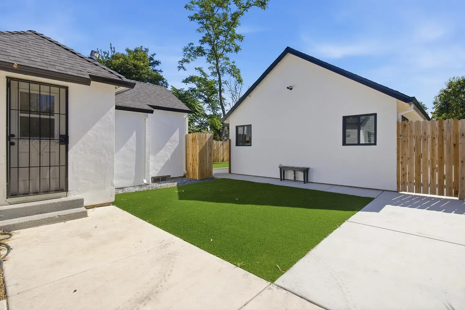 Both homes share one lot, with a private yard in between.