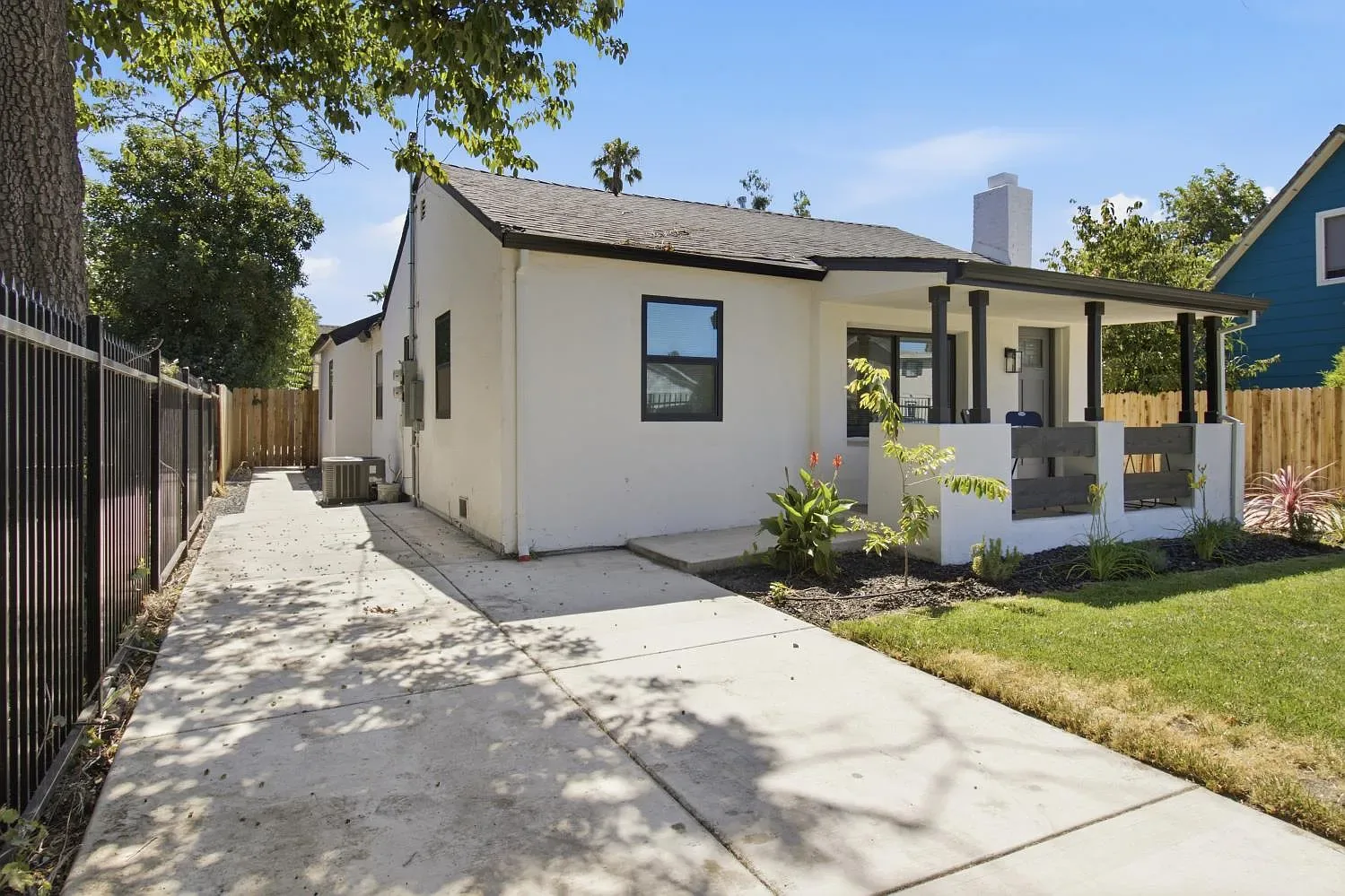 The remodeled 1940s front home, with its covered porch and long driveway.